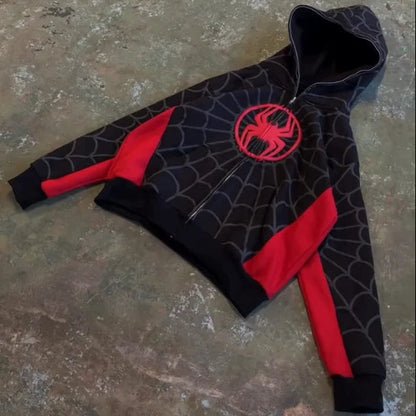 Black hoodie with red spider emblem on a textured surface