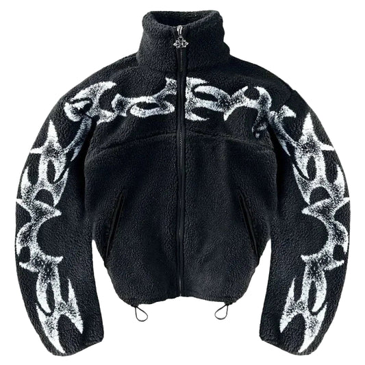 Black jacket with white tribal patterns on a gray concrete surface