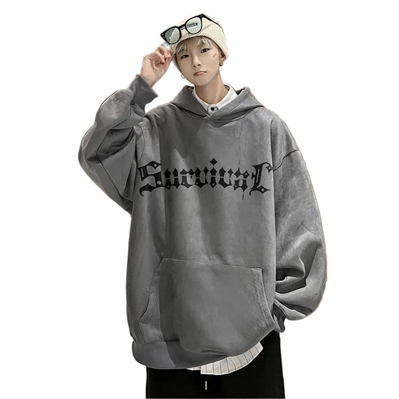 Person wearing a gray hoodie with text in an indoor setting