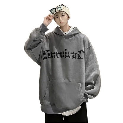 Person wearing a gray hoodie with text in an indoor setting