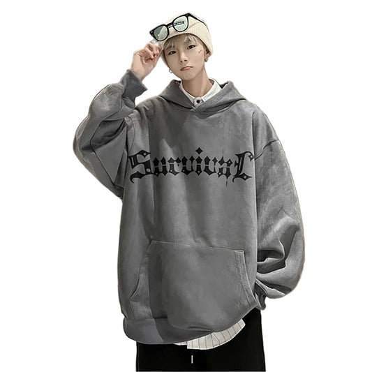 Person wearing a gray hoodie with text in an indoor setting