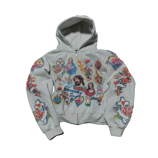 Gray hoodie with colorful graphic designs on a concrete surface