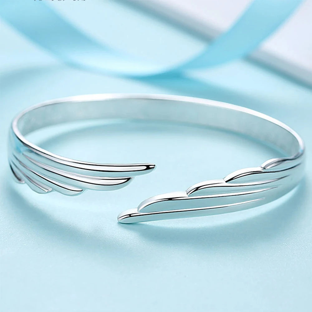 Silver bracelet on a light blue background