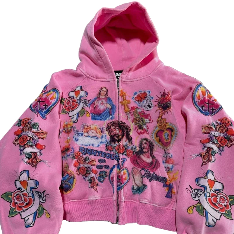 Pink hoodie with colorful graphics and designs on a gray surface