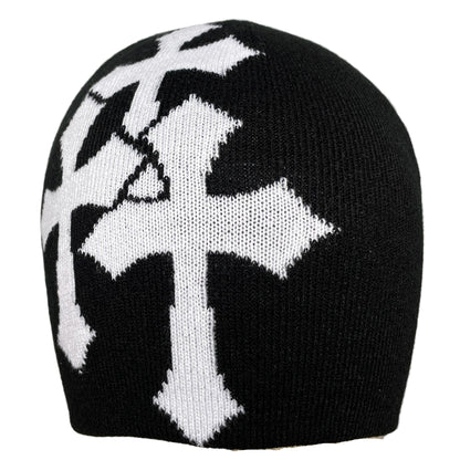 Black knit beanie with white geometric pattern on a mannequin head against a gray background