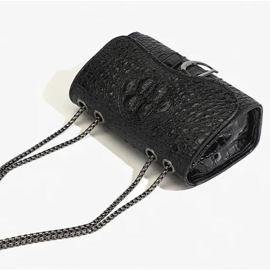 Black textured handbag with chain strap on a white background, featuring the word 'FASHION'.