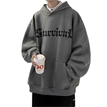 Person wearing a gray hoodie with 'Survivor' text in a kitchen setting