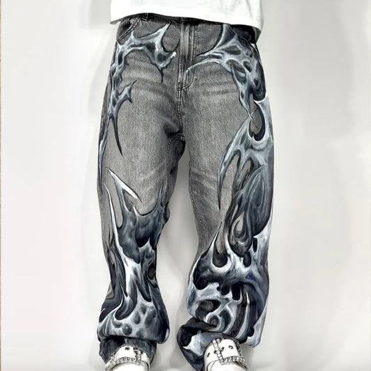 Person wearing gray jeans with flame pattern on a white background