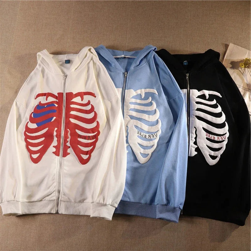 Three hoodies with ribcage designs in red, blue, and black on a beige background