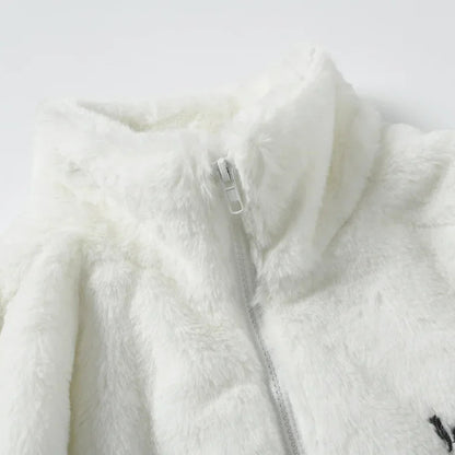 Close-up of a white fleece jacket with a zipper on a light gray background