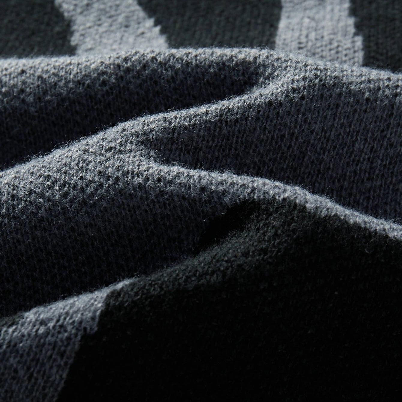 Close-up of textured dark fabric with geometric pattern