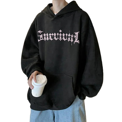 Person wearing a black hoodie with 'Survival' text in a kitchen setting