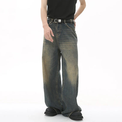 Person wearing a pair of wide-leg jeans on a white background