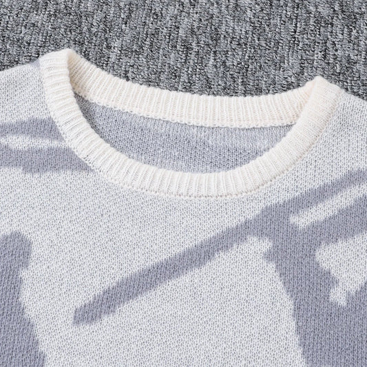 Close-up of a sweater with a pattern on a textured gray background
