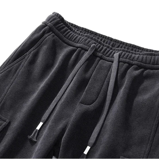 Black sweatpants with drawstring on a white background