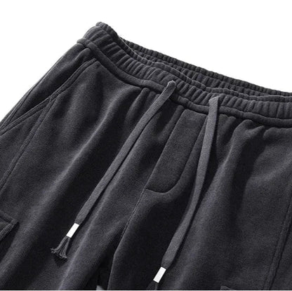 Black sweatpants with drawstring on a white background