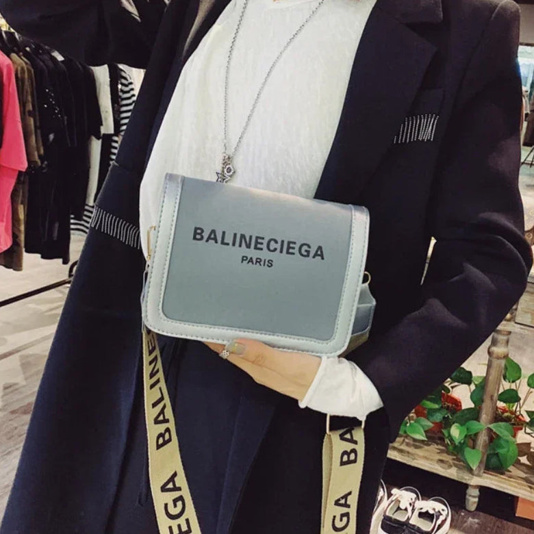 Person wearing a Balineciega bag in a clothing store setting