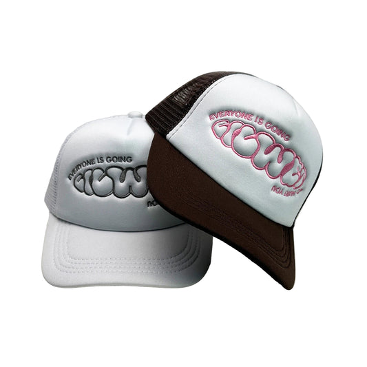 Two white caps with brown visors on a light gray background