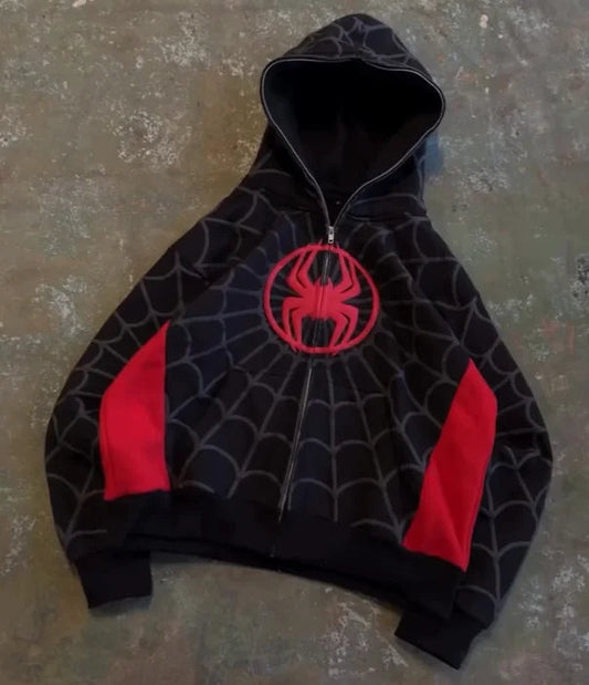 Black hoodie with red spider emblem on a textured surface