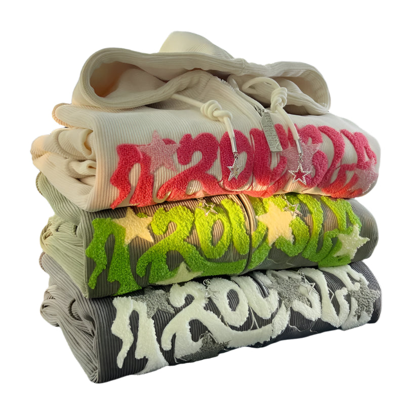 Stack of folded clothes with colorful text design on a black background