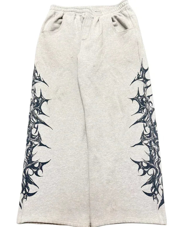 Gray sweatpants with black tribal designs on a white background