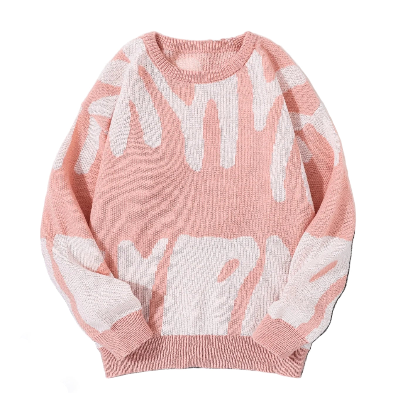 Pink sweater with white abstract patterns on a gray surface with white sneakers and sunglasses.